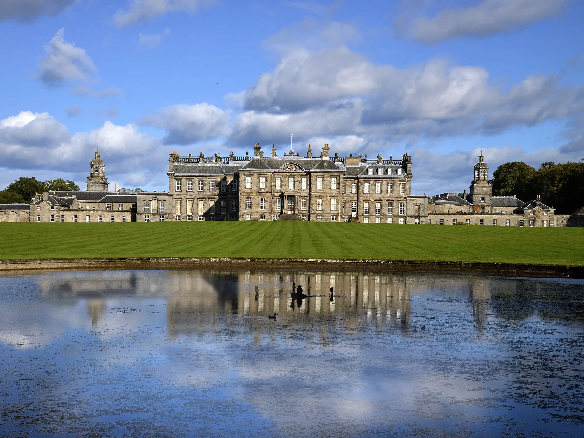Hopetoun House mansion in Queensferry, Scotland, mirrored in the still water in front of it