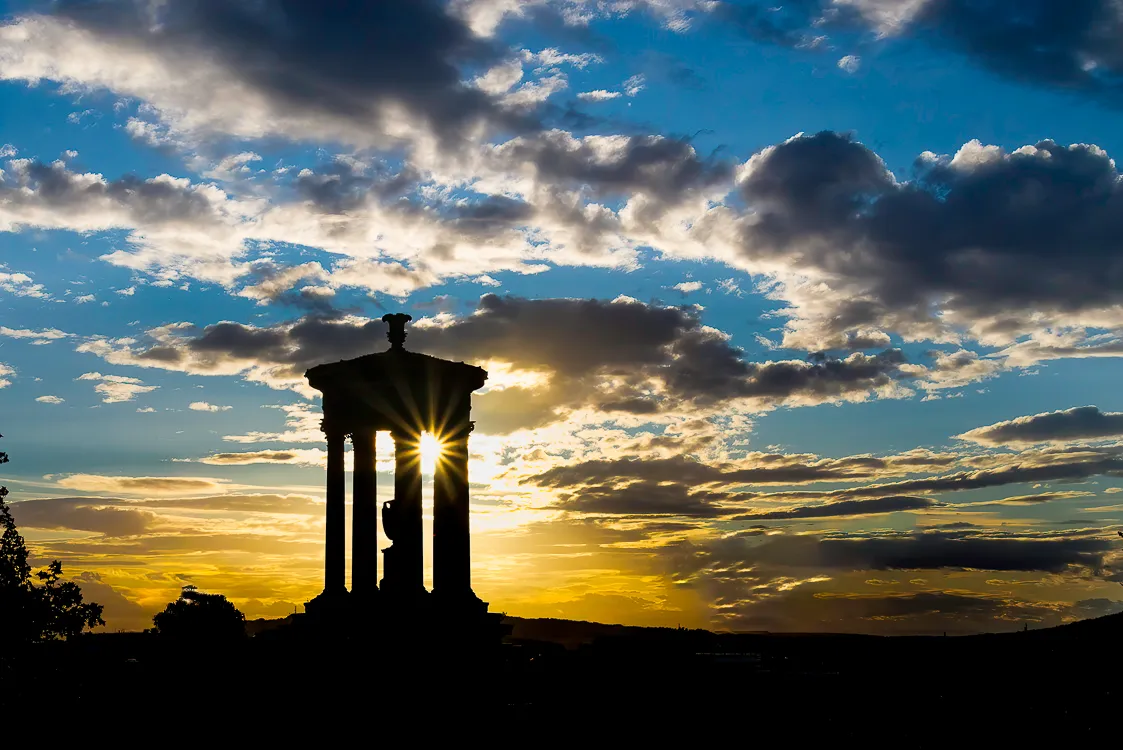 A stone monument standing against an open sky