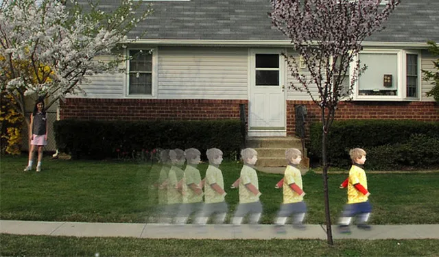 A child running from left to right while another child and a tree anchor the left side of the frame
